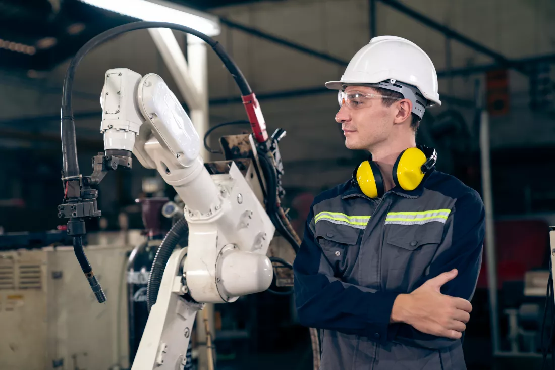 young-factory-worker-working-with-adept-robotic-arm(1)