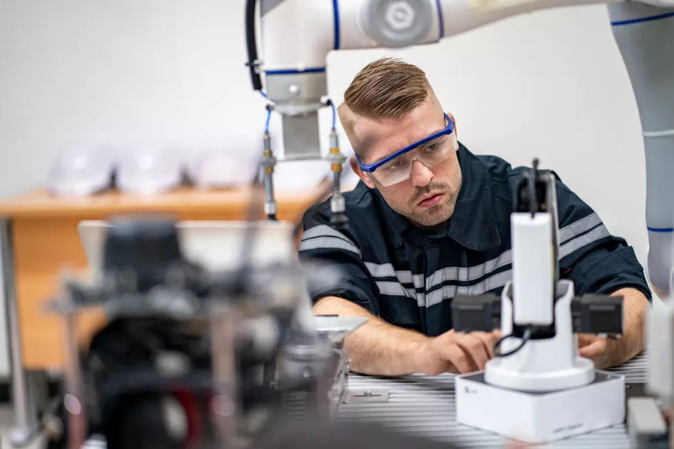 engineer-man-working-industrial-robot-factory-industrial-robotics-digital-manufacturing-operation