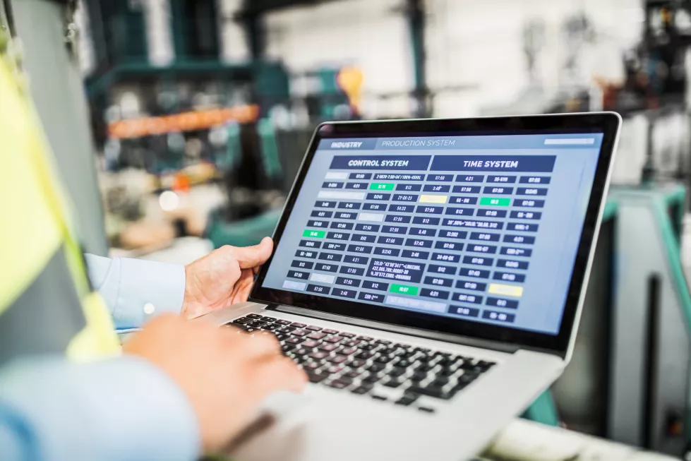 midsection-industrial-man-engineer-with-laptop-factory-working