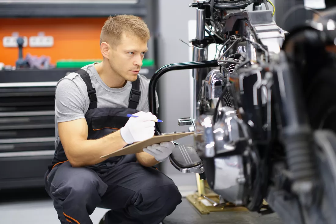 motorcycle-repairman-takes-notes-close-up