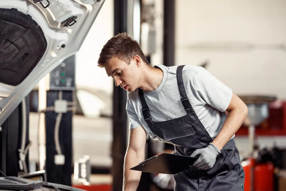 young-automechanic-is-checking-results-his-work-car-service