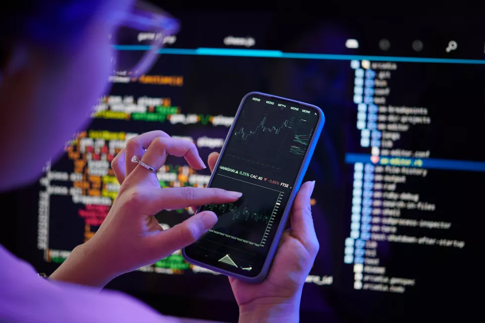examining-code-smartphone-while-sitting-desk