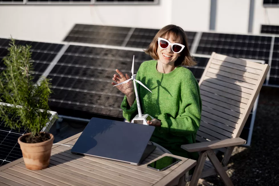 woman-with-toy-wind-generator-rooftop-with-solar-power-plant