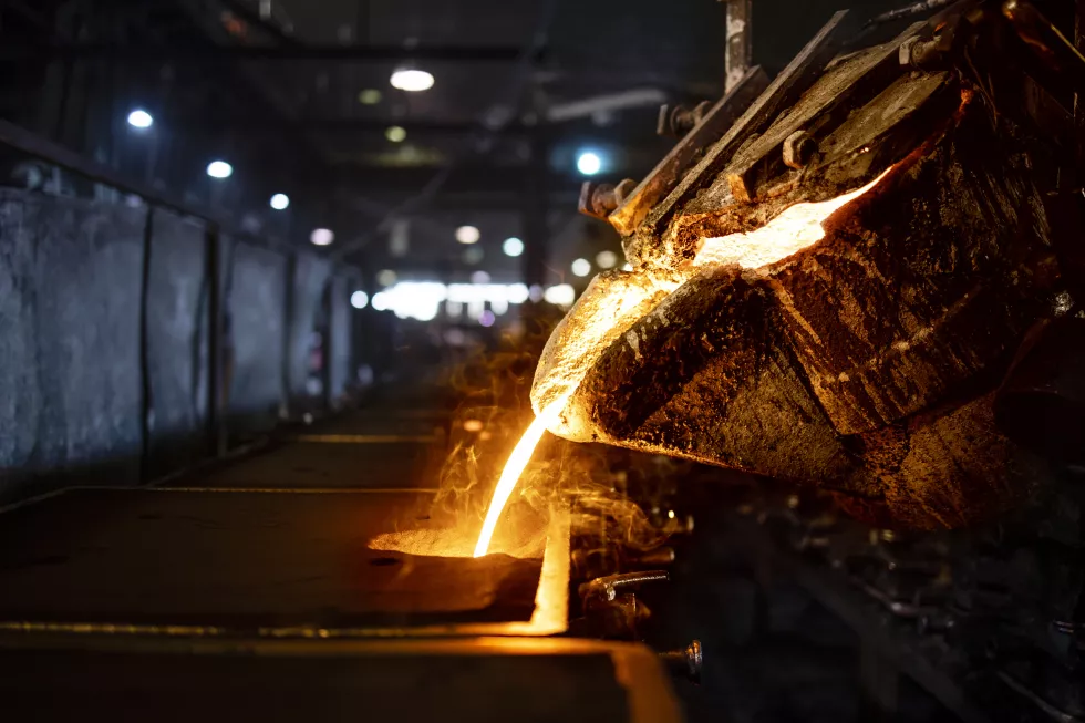 bucket-with-hot-molten-iron-pouring-into-mold-industrial-steel-production-casting-melting-molding-foundry