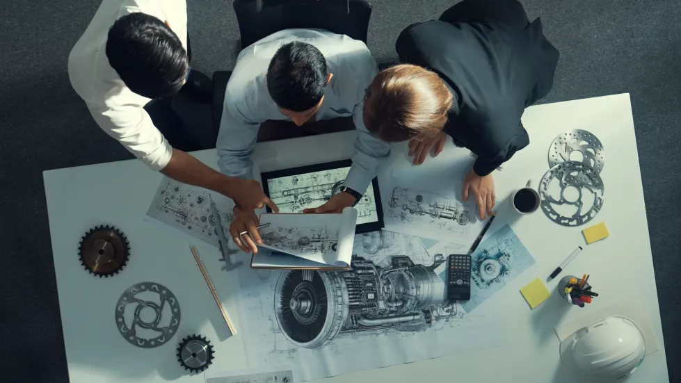 top-view-engineer-working-together-while-looking-jet-engine-alimentation