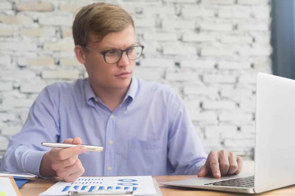 young-businessman-working-desk-office