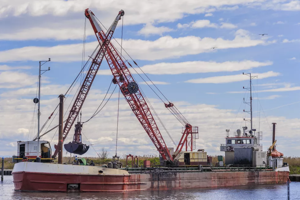 low-angle-view-cranes-against-sky