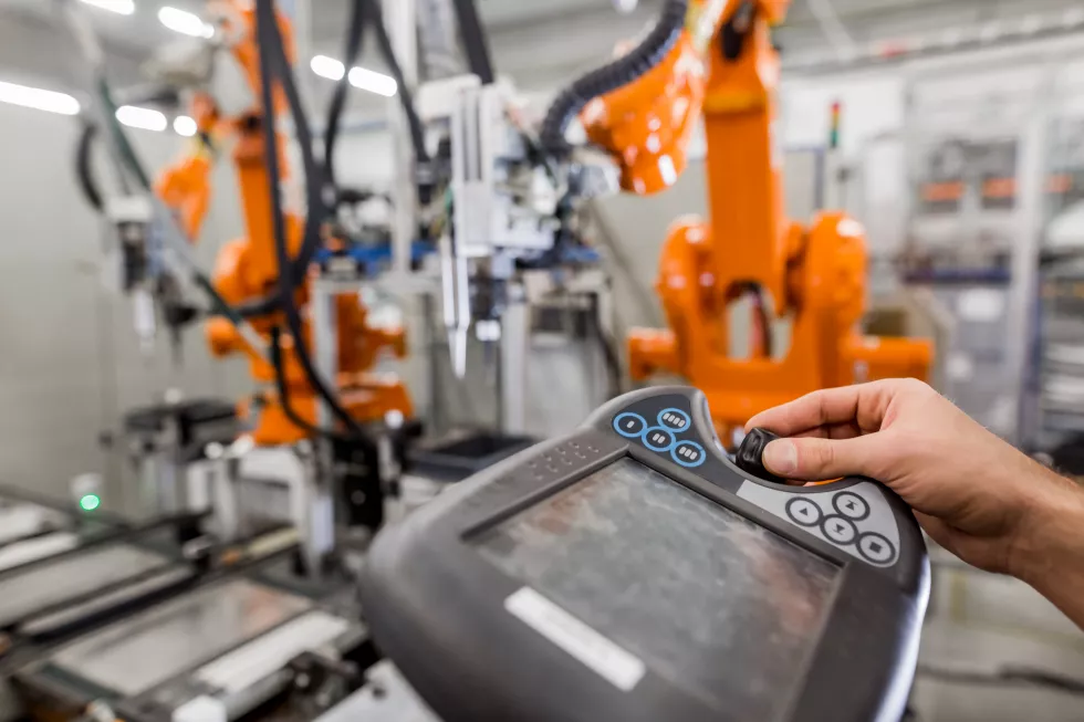 cropped-hand-worker-using-machinery-factory