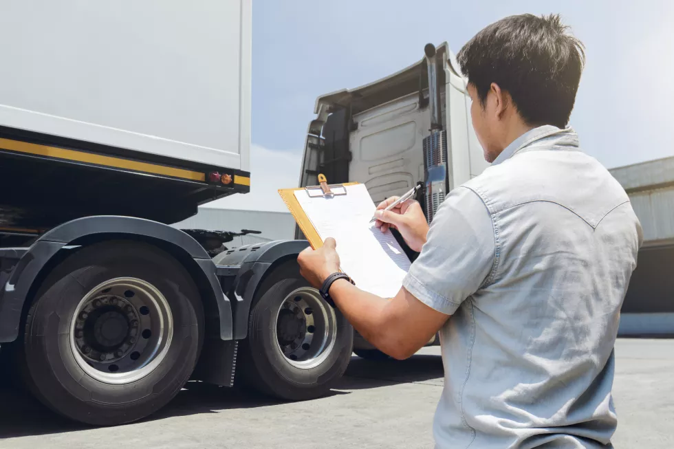 asian-truck-driver-is-checking-trucks-safety-maintenance-checklist-lorry-inspection-wheels-tire