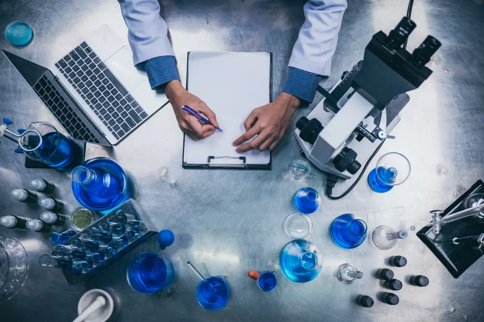 top-view-workspace-laboratory-with-microscope-laptop-laboratory-tools