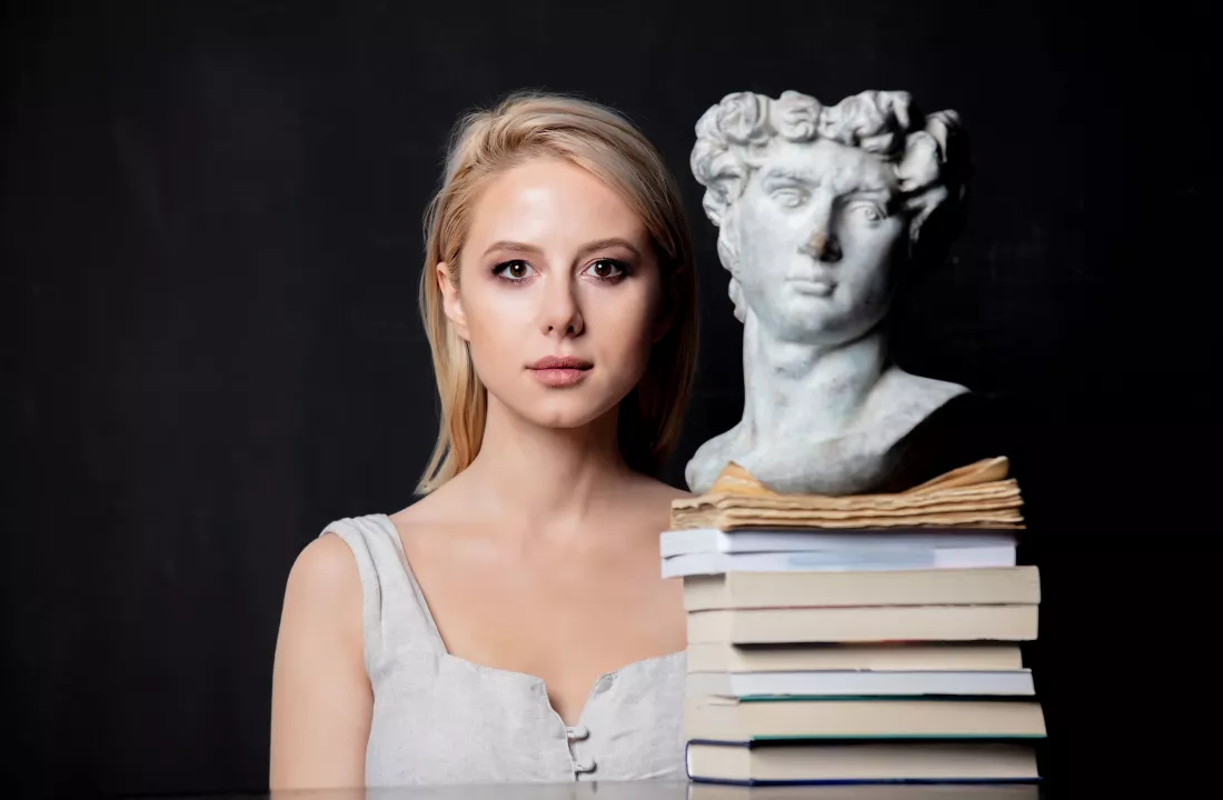 blonde-woman-antique-bust-man-books-1