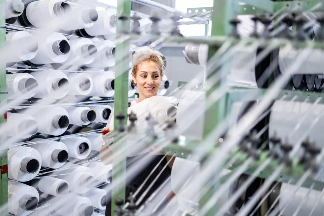 female-textile-factory-worker-changing-thread-spool-industrial-knitting-machine