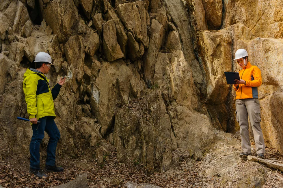 male-female-geologists-takes-sample-mineral-record-data-canyon