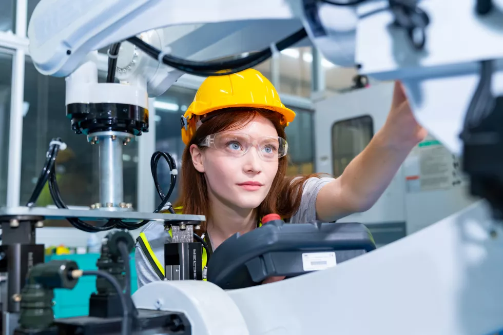 manufacturing-industry-factory-manufacturing-technology-concept-professional-woman-technician-engineer-safety-wear-checking-robotic-machine-arm-system-production-line-repair-maintenance