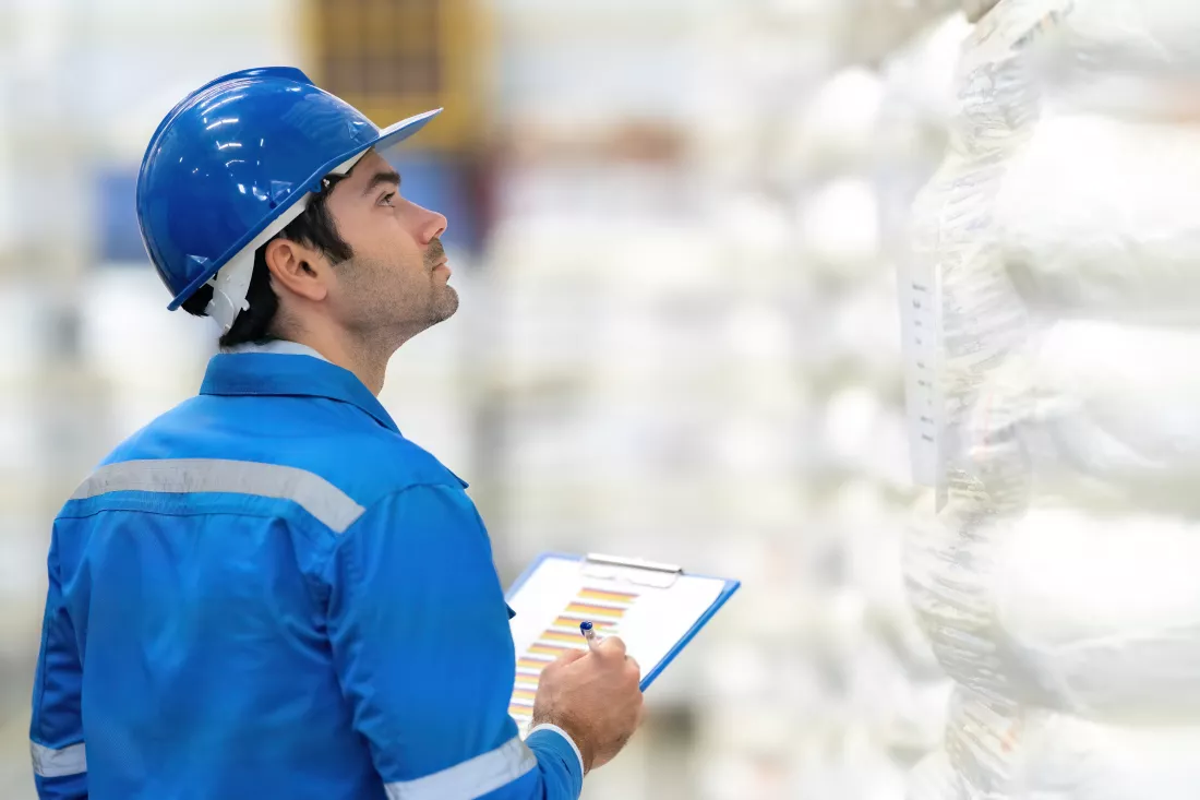 european-white-male-engineer-checking-warehouse-plastic-industry-make-plans-commercial-business-wear-helmet-uniform-holding-pen-list-note