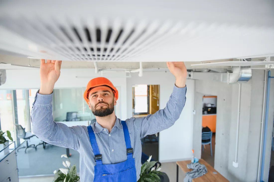 technician-service-checking-repairing-air-conditioner-indoors