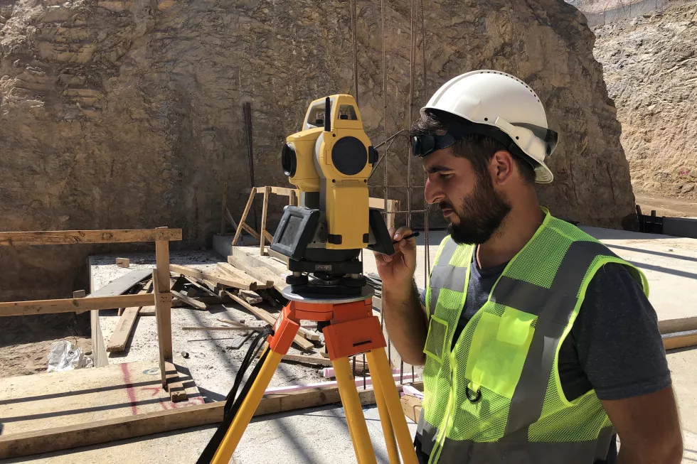 portrait-young-man-standing-construction-site
