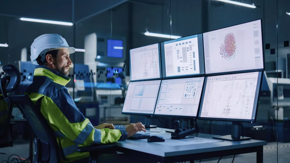 industry-40-modern-factory-facility-operator-controls-workshop-production-line-uses-computer-with-screens-showing-complex-ui-machine-operation-processes-controllers-machinery-blueprints