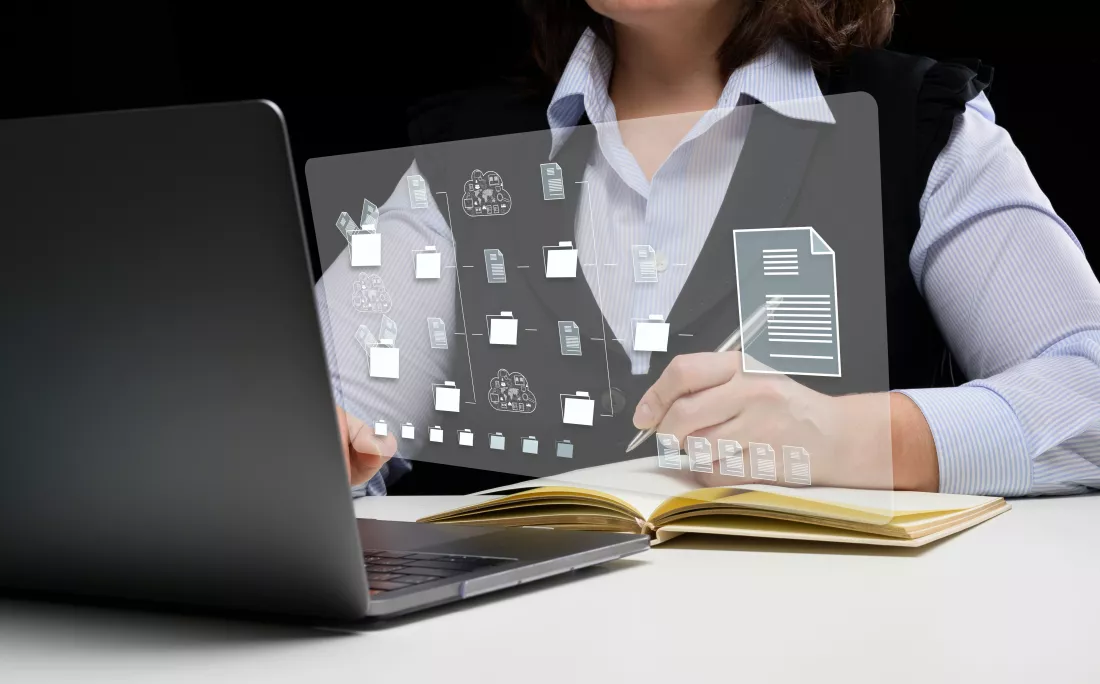 woman-sits-table-works-with-laptop-document-management-mystem-dms-software-automating-archiving-efficient-management-information-files(2)