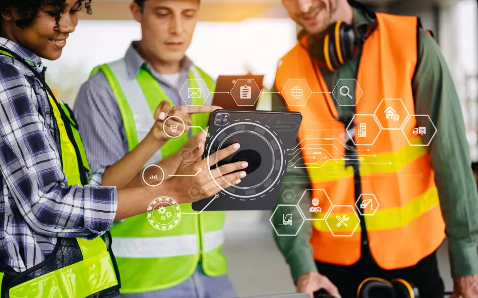 colleagues-discussing-data-working-tablet-laptop-with-architectural-project-construction-site-desk-officexa
