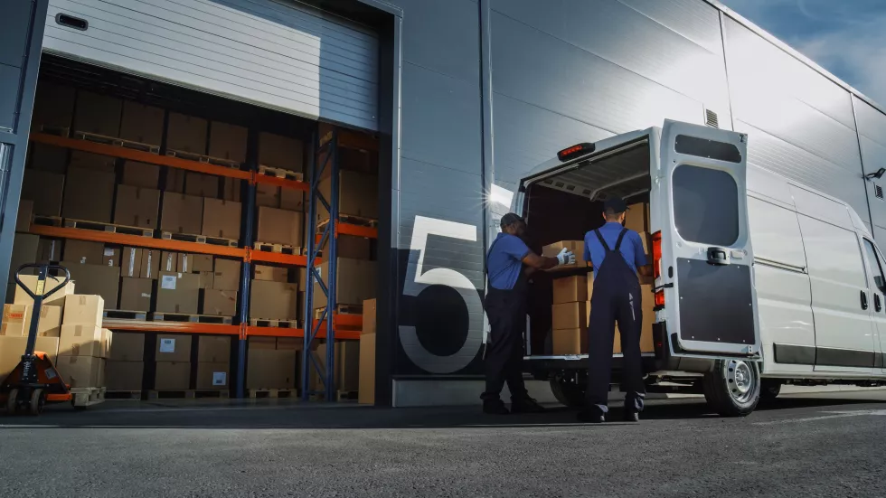 outside-logistics-distributions-warehouse-two-workers-load-delivery-truck-with-cardboard-boxes-online-orders-purchases-ecommerce-goods